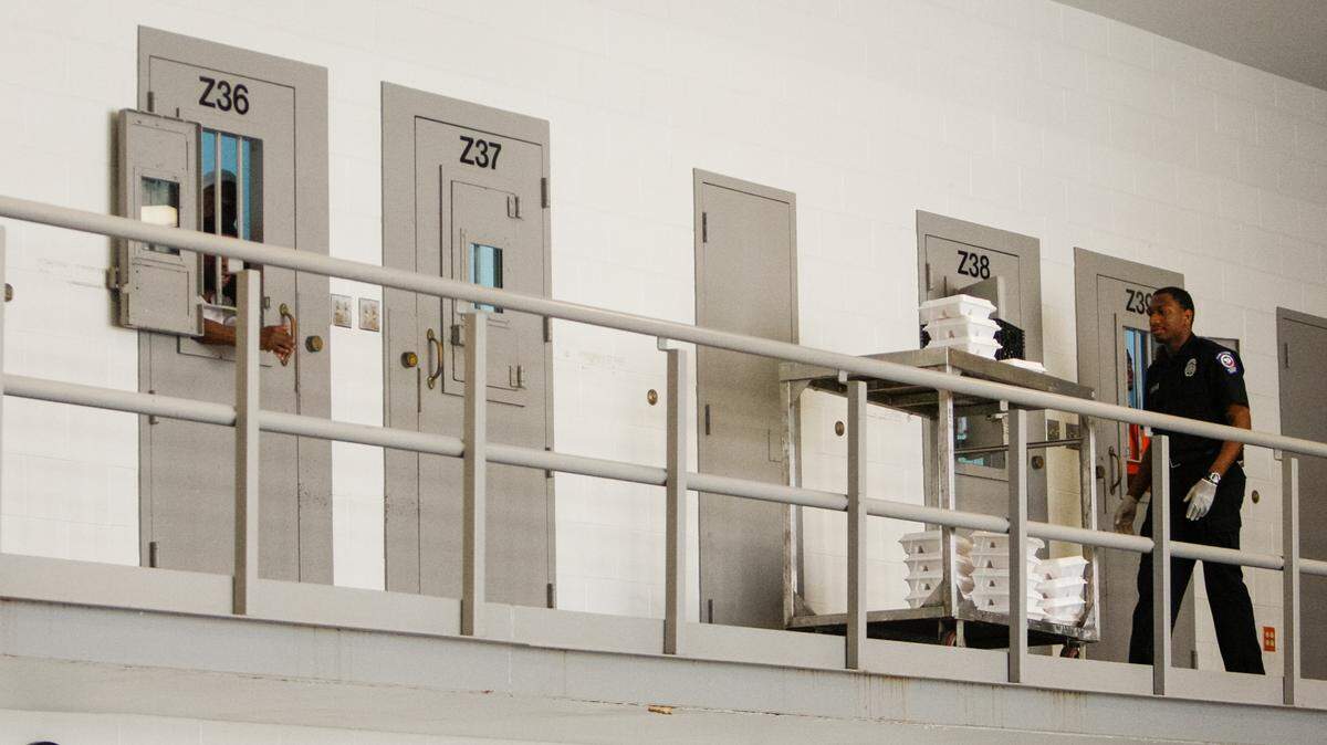 In this file photo from 2013, a correctional officer gives meals to people incarcerated at the Alvin S. Glenn Detention Center, a Richland County jail located just outside of Columbia city limits. Since 2009, at least 18 people have died in the custody of the jail, according to data compiled by The Island Packet.