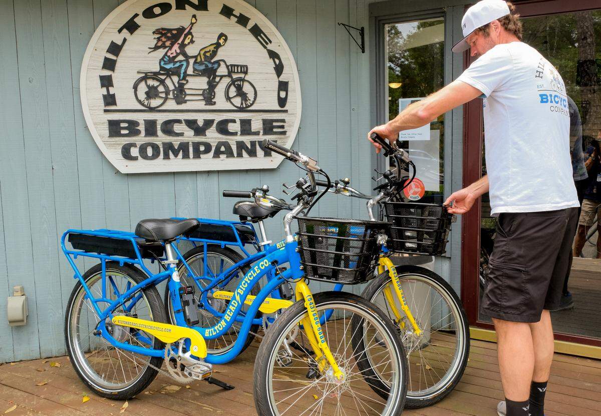 Philip Balvocius, electric manager at Hilton Head Bicycle Company displays two of several electric bikes on Tuesday, April 20, 2021 that were custom made in California. “I gave a two-hour tour this morning and we went all over the island”, Balvocius said when talking about the battery’s 100-mile range. 