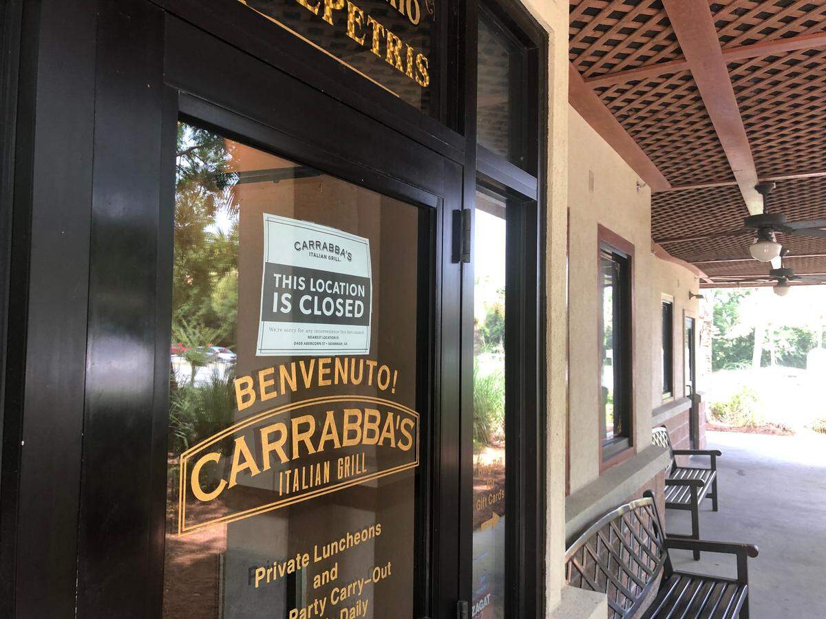 A sign posted on the door of Carrabba’s on Hilton Head directs customers to the Savannah location of the Italian restaurant chain on Friday, June 26.