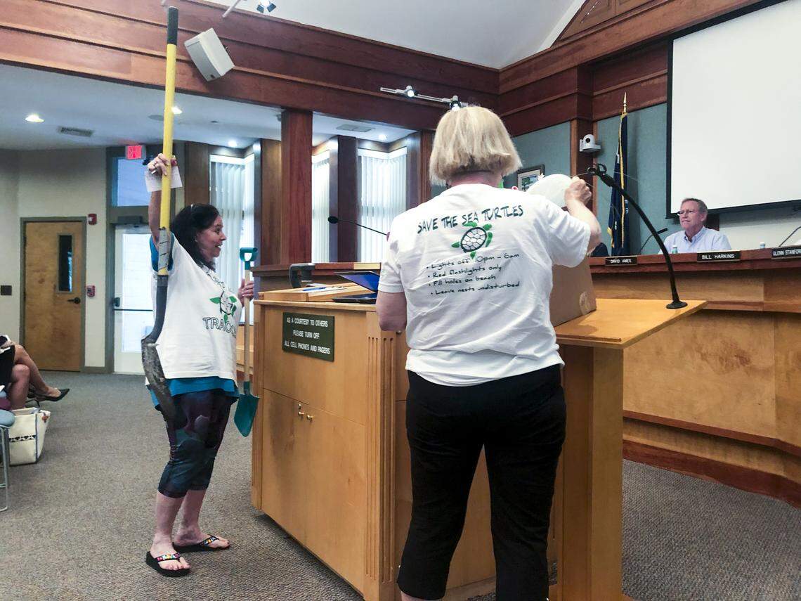 Deborah Urato hoists a garden shovel into the air in front of the public planning committee on June 27. Urato is a member of the Turtle Trackers of Hilton Head Island, a group that wants to ban garden shovels used to dig big holes on the beach.