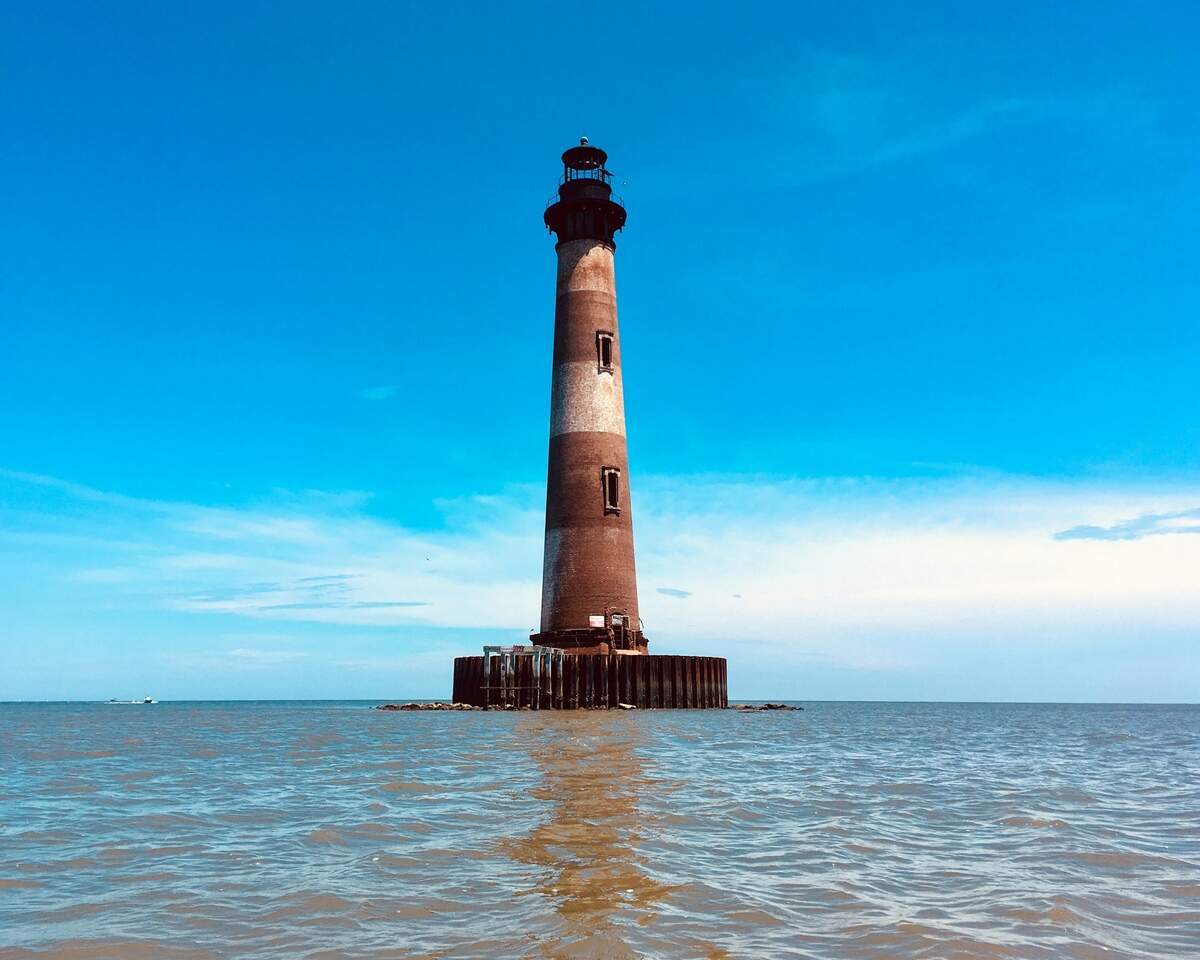 The Morris Island Lighthouse near Charleston was built in 1876. Soon the sea eroded the surrounding island, and though it is no longer a serviceable light, it stands today in mute testimony to the power of the sea - and as a magnet for beach-goers and boaters.