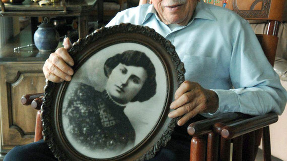 Polish Holocaust survivor Allen Kupfer holds a picture of his mother, Bruch, at his home in Sun City Hilton Head. Kupfer was reunited with his sister after World War II, but his parents died in concentration camps.