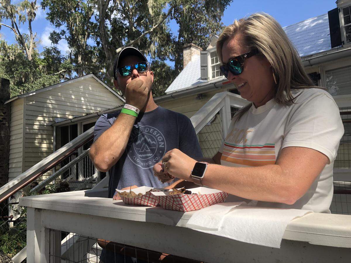 Bluffton residents Matt and Courtney Timen crack open the shells of their boiled peanuts at the 8th Annual Bluffton Boiled Peanut Festival in Old Town Bluffton. This was the fourth year coming to the festival which Matt said is all about southern food and hospitality.