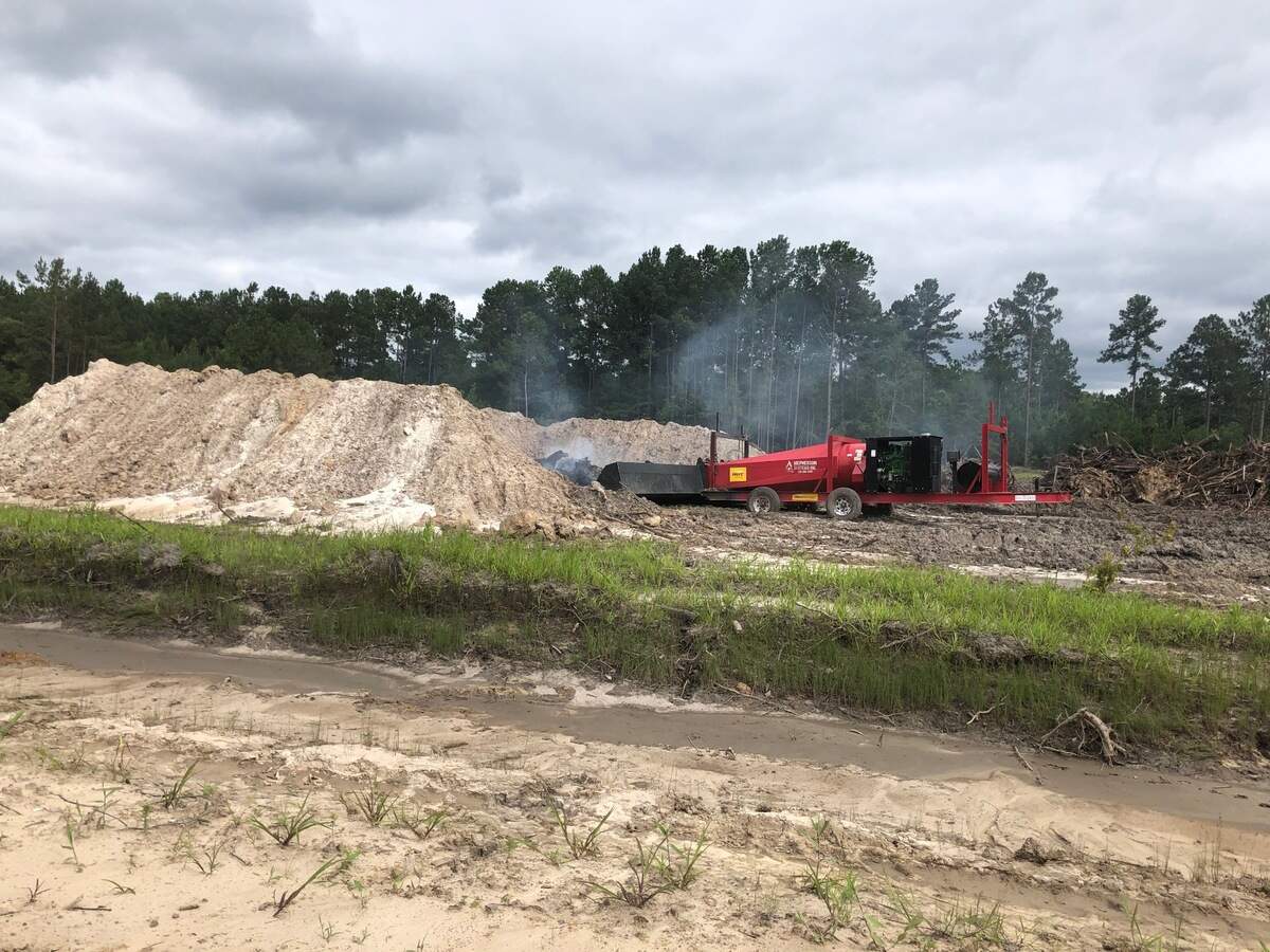 A photo of the enhanced air burner used by Dustcom Limited to burn trees after they are cut at the addition to Sun City Hilton Head.
