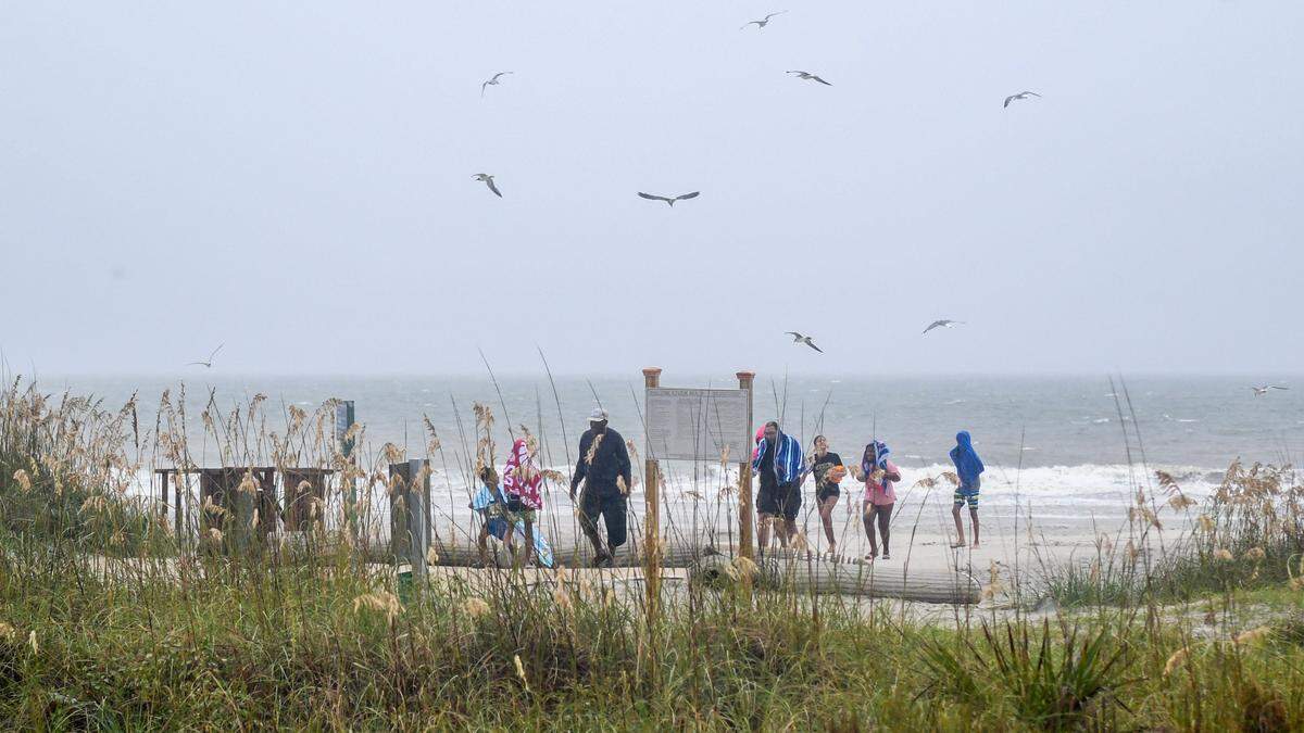 Genee Leonard’s family brave the winds and rain from Tropical Storm Debby at Coligny Beach on August. 5, 2024 on Hilton Head Island. Leonard and her family drove down to Hilton Head from West Virginia and will be here for the duration of the storm.