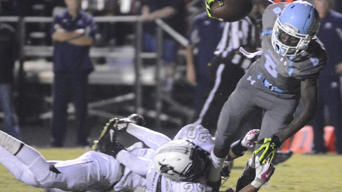Hilton Head ballcarrier Tyler Hamilton teeters in for a touchdown during Friday?s Bridge Bowl game with Bluffton. 