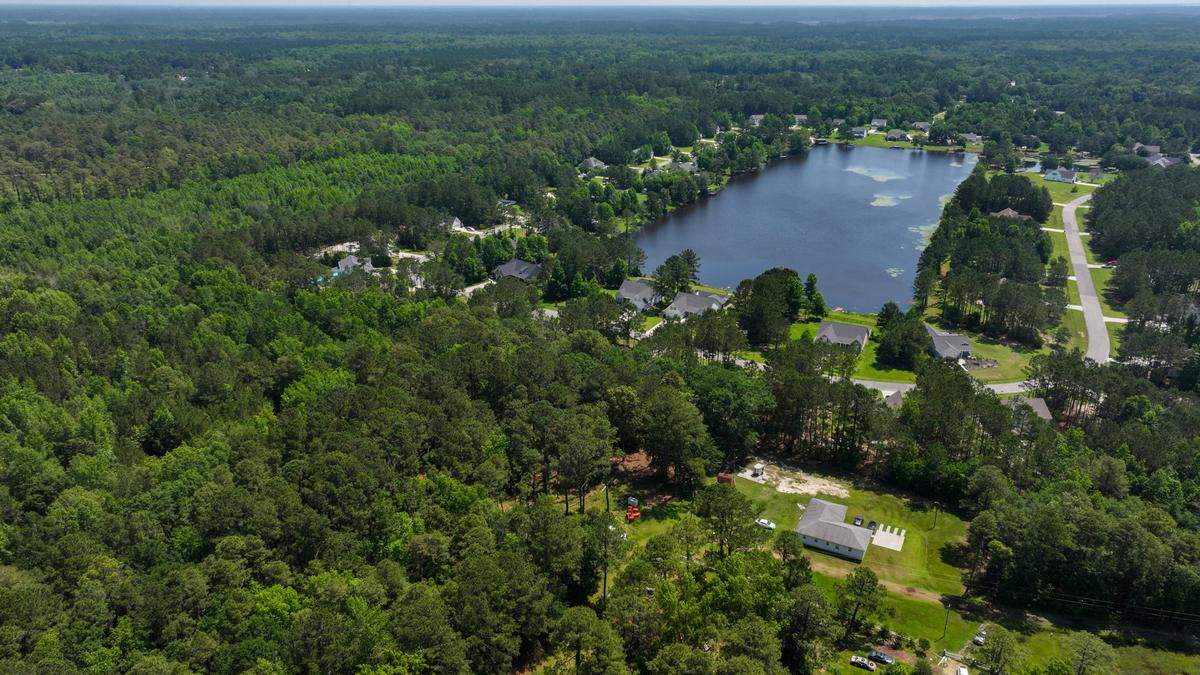 The private community of Osprey Lake is photographed with a drone on May 20, 2025, its gated entrance at the top of the photo is located in Levy, S.C. In April, CFH Monroe submitted an application for a permit to operate a sand mine in the forested area that abuts the row of homes on the left, the mines 62-acres not fully captured in this photo.