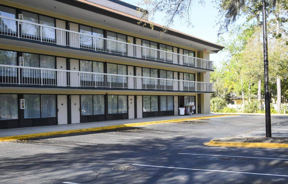 A housekeeper’s supply cart sits outside a room on Friday, March 20, 2020, in an empty parking lot behind Simple Rewards Inn on Hilton Head Island.