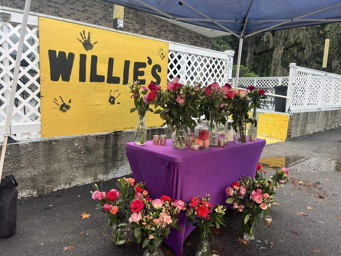 Community members erected a memorial of flowers and candles outside of Willie’s Bar and Grill after a mass shooting killed four people at the venue during a high school alumni event around 1 a.m. on Oct. 12, 2025.
