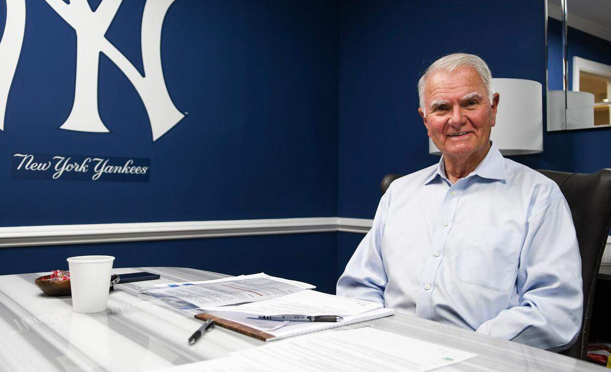 John McCann, mayor of Hilton Head Island, poses for a photo amongst the royal blue walls and a logo for Major League Baseball’s New York Yankees in his newly decorated office at town hall. Instead of a traditional desk with drawers, McCann chose a table with a marble top.