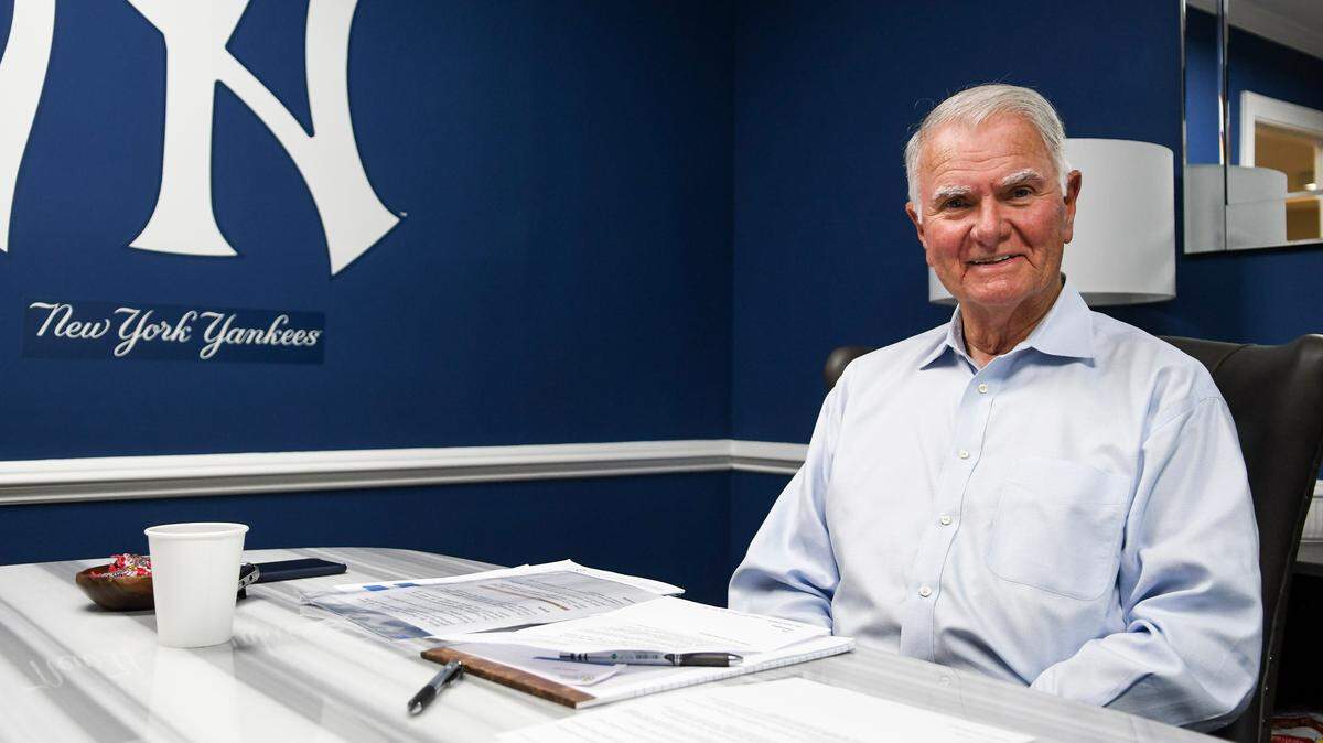 John McCann, mayor of Hilton Head Island, poses for a photo on Wednesday afternoon amongst the royal blue walls and a logo for Major League Baseball’s New York Yankees in his newly decorated office at town hall. Instead of a traditional desk with drawers, McCann chose a table with a marble top.