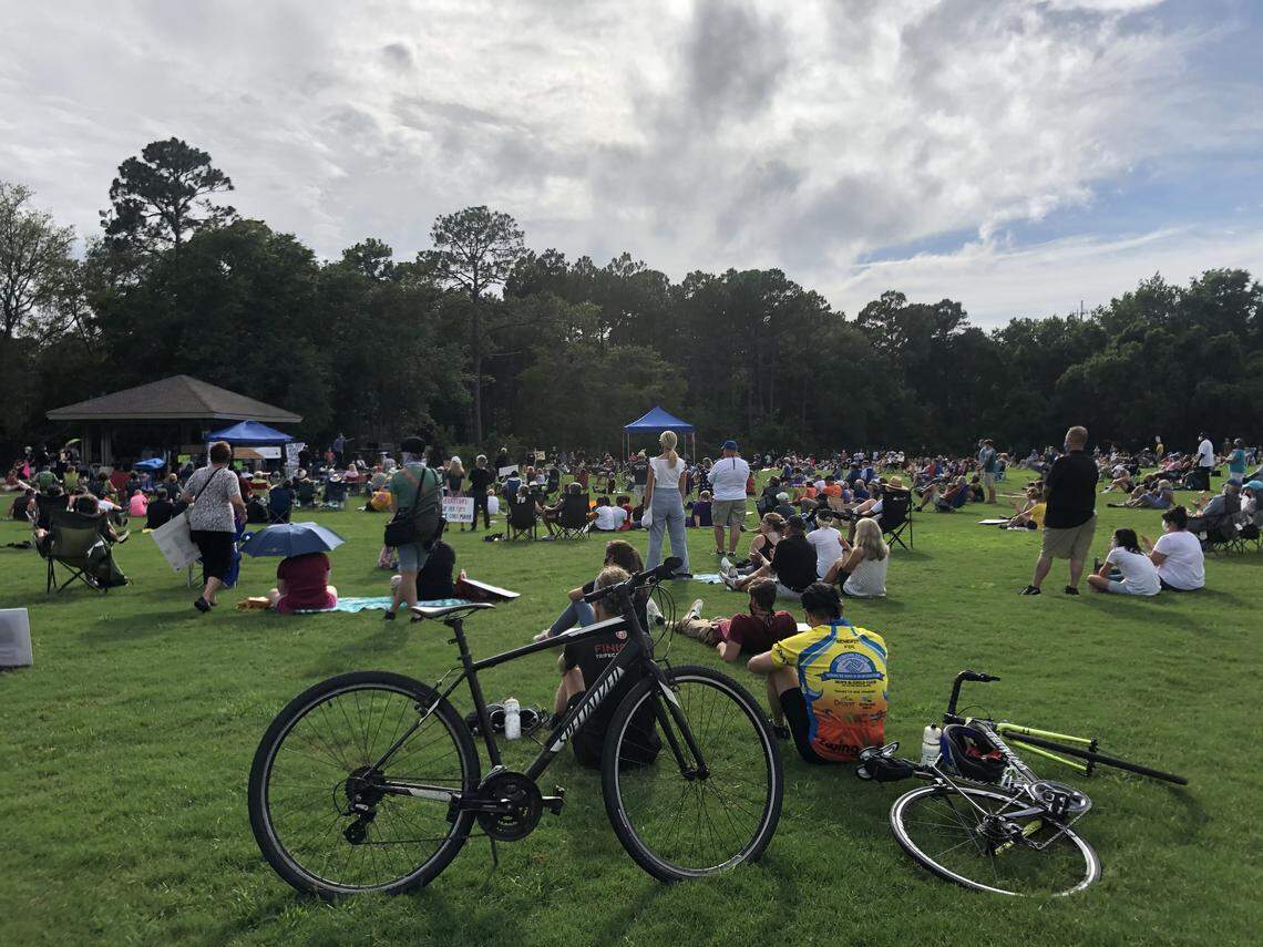 A pair of cyclists sit at Chaplin Park on Hilton Head Island Sunday, June 7 and listen to speakers with the Rally for Justice and Change, which was organized to advocate for an end to police brutality and racism. Around 1,000 people attended.