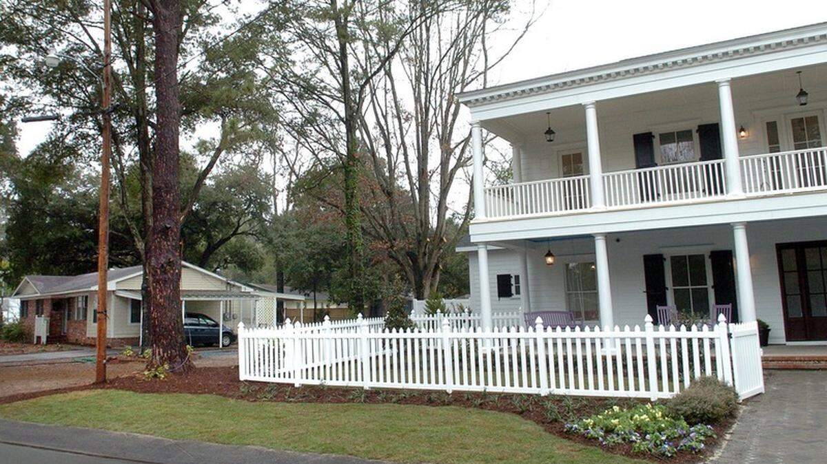 The Dickinsons' new plantation-style home on Mystic Circle, right, built as part of ABC's "Extreme Makeover: Home Edition," towers over the one-story ranch homes that make up the neighborhood.