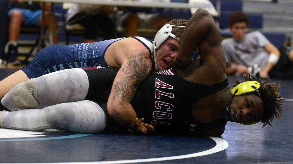 Hilton Head Island High's Talon Seitz tries to maintain his hold on Alcoa's Karim Shereef on Thursday afternoon during the 170 lb. match in the semifinals of the Seahawk Duals at Hilton Head Island High School.