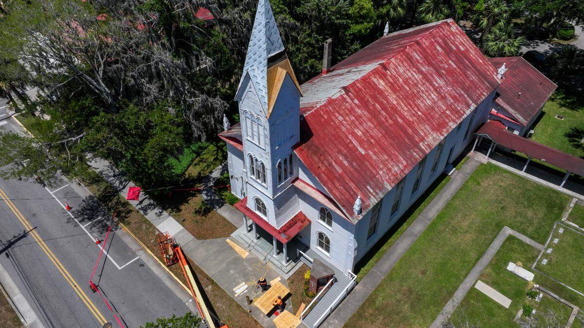 This drone photo shows workers with Savannah-based Metalcrafts, a Tecta America Company, work on April 30, 2025, to repair the 65-foot tall steeple of the Tabernacle Baptist Church in Historic Downtown Beaufort.