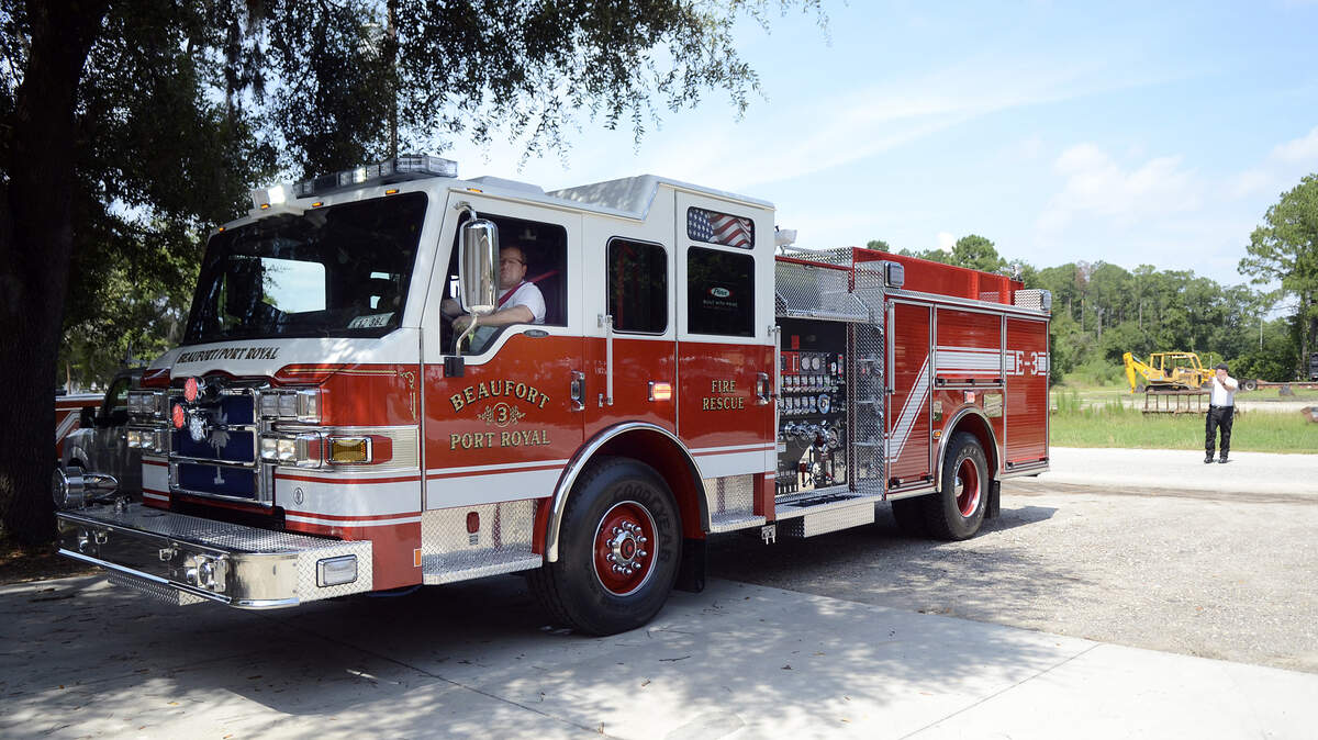Lt. Gary Guldner backs up the new fire engine for the Beaufort-Port Royal Fire Department with help from Firefighter Clint Holmes on July 16, 2014, after the radios and receivers were installed at the Beaufort County Public Works yard in Beaufort.