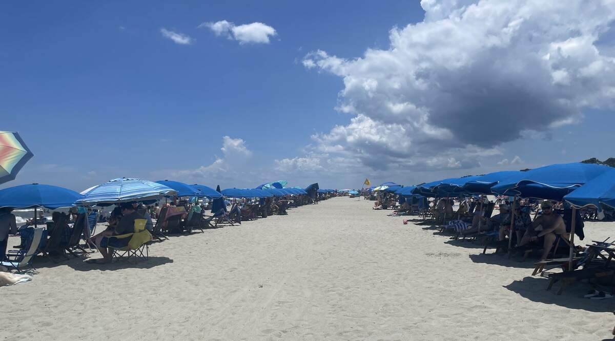 Tourists pack Coligny Beach on Monday, July 6, 2026, less than 48 hours after a shooting on the evening of the Fourth of July sent crowds running.