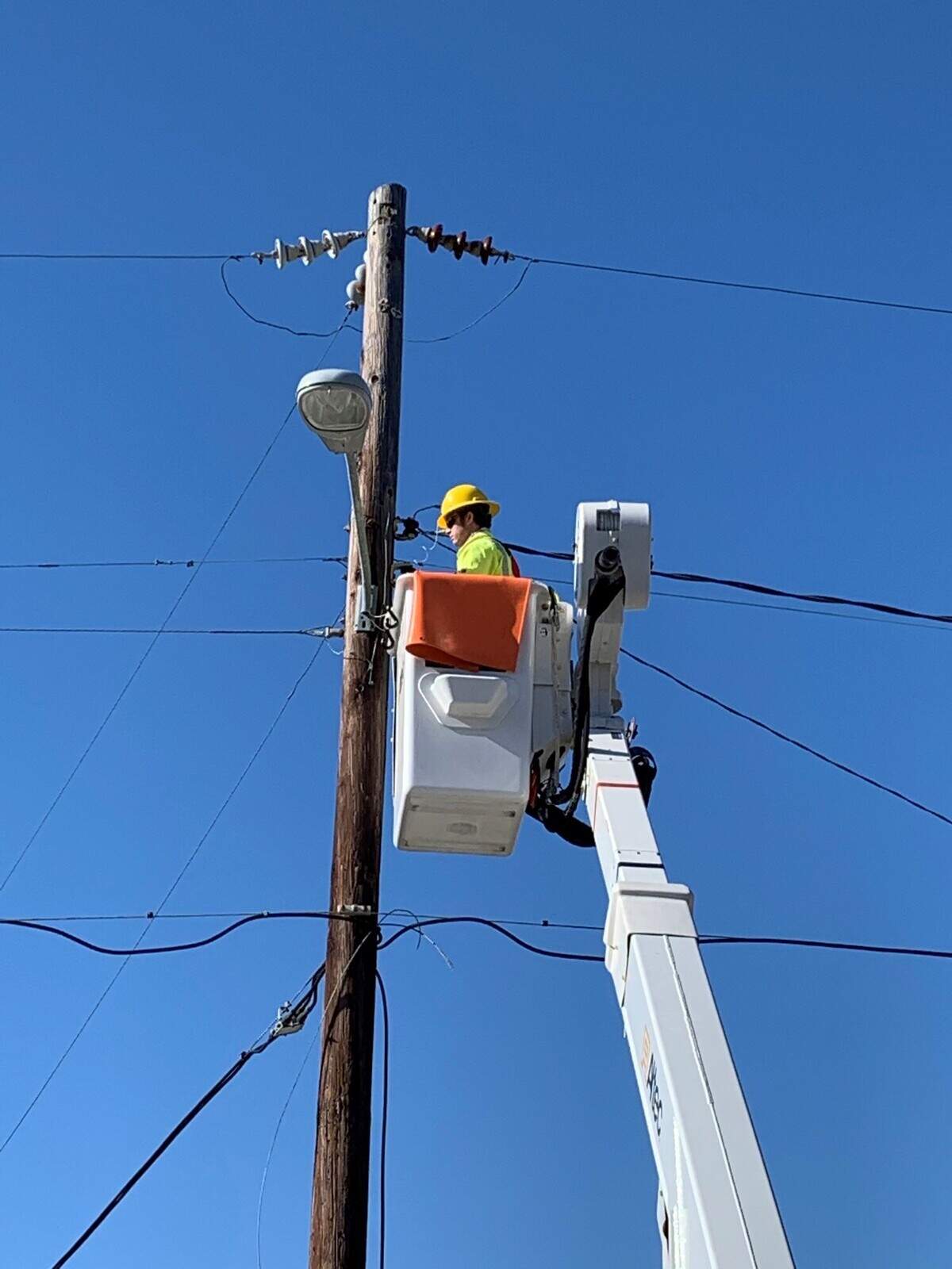 A Dominion Energy contractor works on installing an LED light in Folly Beach. Dominion will replaced between 800 and 900 lights in Beaufort.