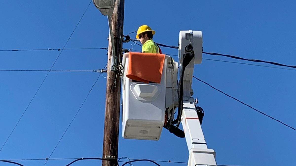 A Dominion Energy contractor works on installing an LED light in Folly Beach. Dominion will replaced between 800 and 900 lights in Beaufort.