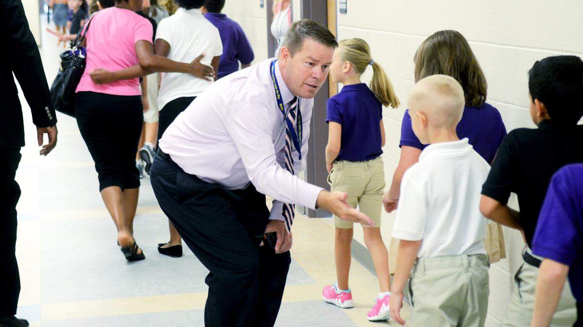 Principal Gary McCulloch greets students in the hallway at River Ridge Academy in Bluffton.