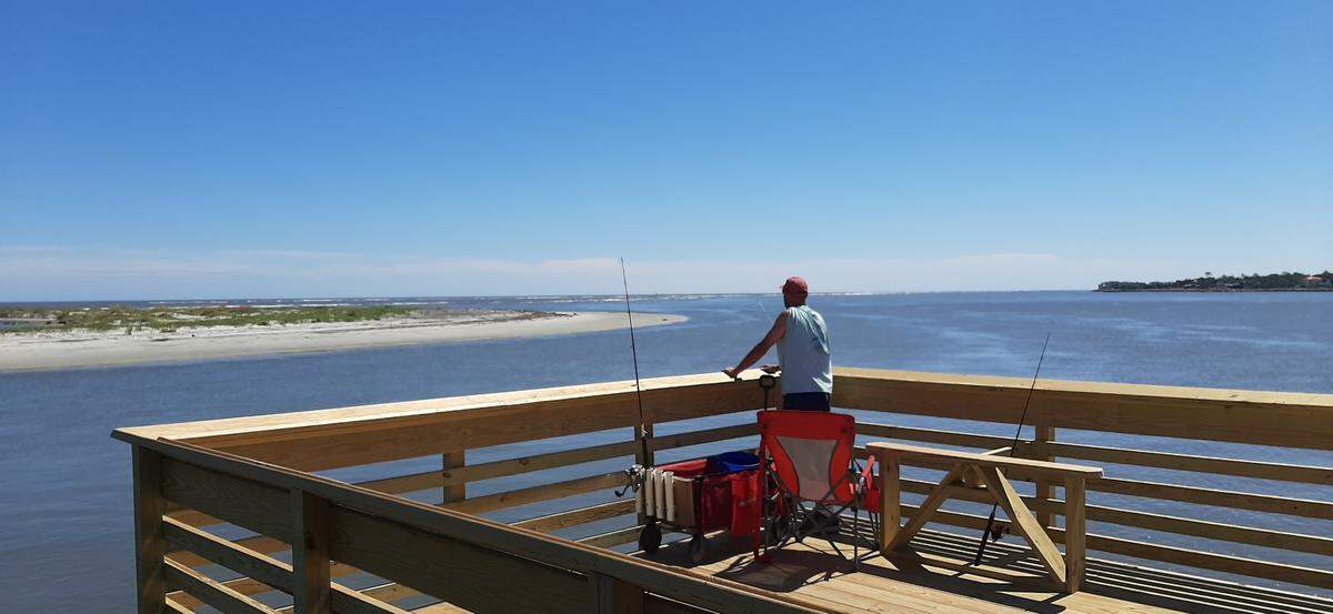 A fisherman enjoys the view of the Atlantic Ocean on the Hunting Island State Park pier Thursday. The pier, closed after Hurricane Matthew damaged it in 2016, reopened Saturday, Sept. 18.