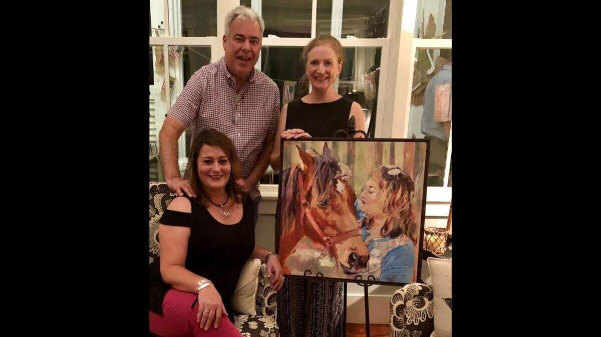 Lori and Peter Kraft with artist Murray Sease and the early Christmas surprise.
