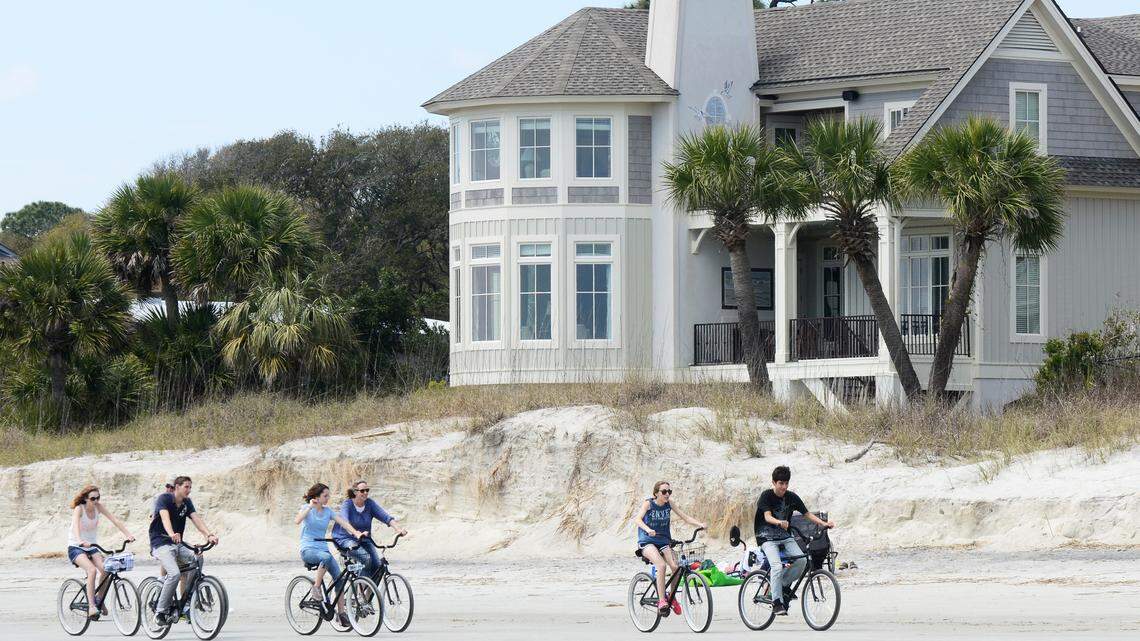 File: Bicyclists pedal past an eroded stretch of North Forest Beach on April 1, 2015, that has been slated for renourishment in 2016.