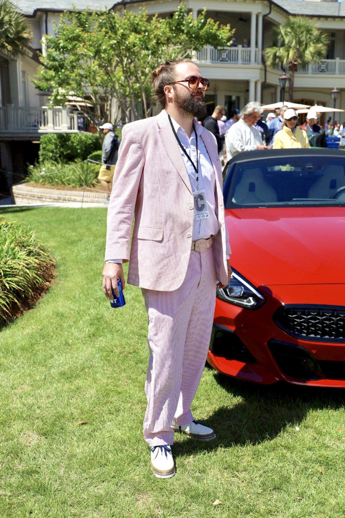 Phil Sirmons, a local of Hilton Head, makes dressing in an all white and pink striped suit look incredibly easy. Paired with tinted sunglasses, a statement belt and white shoes, Phil’s outfit is a great choice for a sunny day at Heritage. Closeby, Adam Ruonala of Charleston makes his Heritage appearance in a bright pink and neon green Lilly Pulitzer suit.