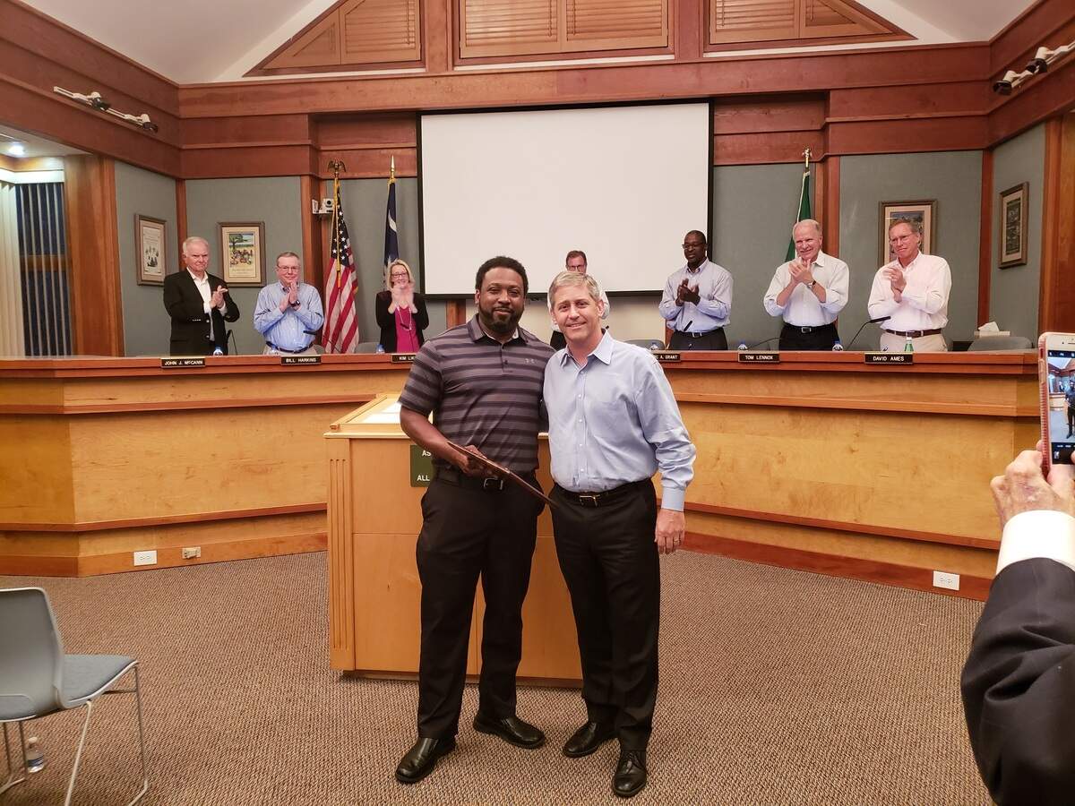 Alex Brown Jr., left, a fifth-generation Hilton Head Islander, presents a plaque of appreciation to David Bennett at his last Town Council meeting as mayor on Nov. 7, 2018.