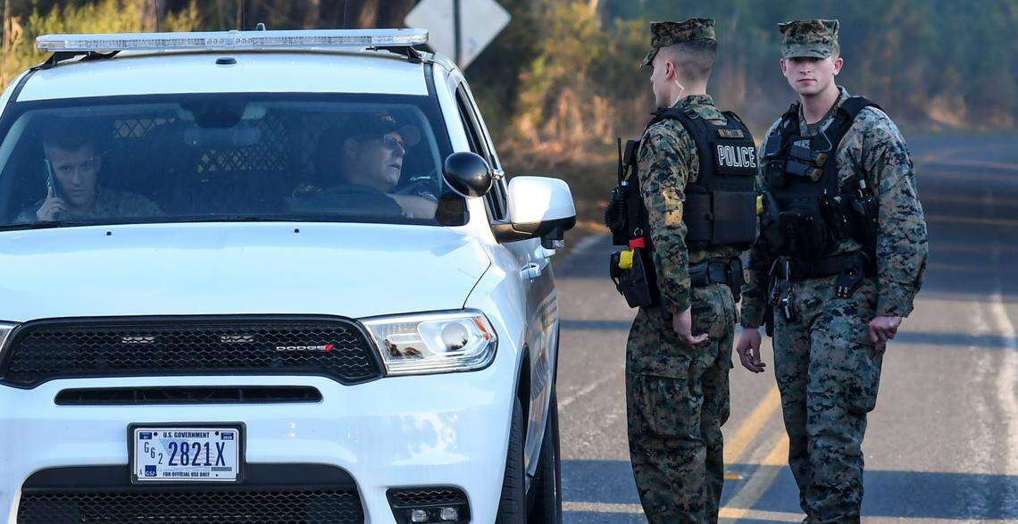 Marine Corps Police block the road on Thursday, Feb. 3, 2022 at Witsell Road near Cattle Egret Lane after a military jet crashed near Halfmoon Island in Beaufort County.