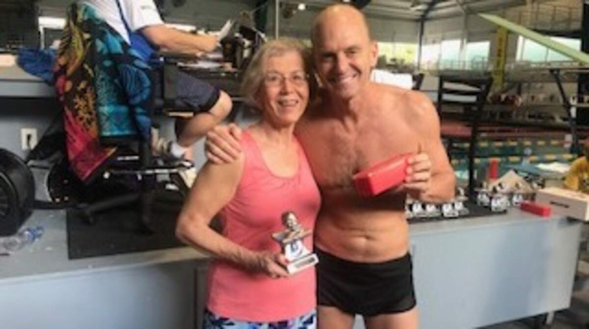 Sun City swimmer Elayne Bartholomew poses with Rowdy Gaines after capturing high-point awards in her age group at Rowdy Gaines Classic.