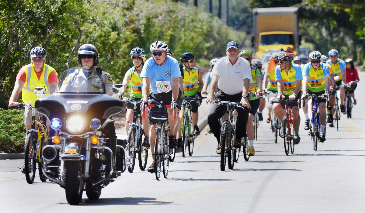 Bicyclists, escorted by a Beaufort County Sheriff’s deputy, arrive at Town Hall after a commemorative ride in 2013.