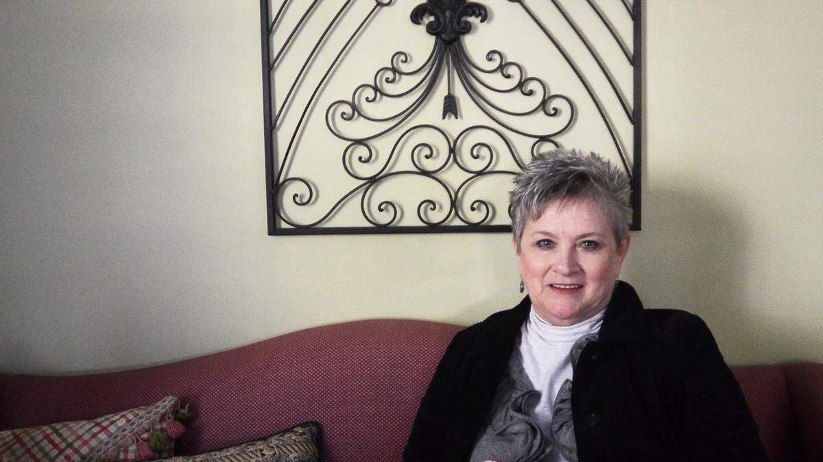 Child Abuse Prevention Association director Susan Cato is retiring after 29 years with the organization. She is photographed in her Port Royal office with quilts made by local quilting associations that are given to children who stay in the association's shelter.