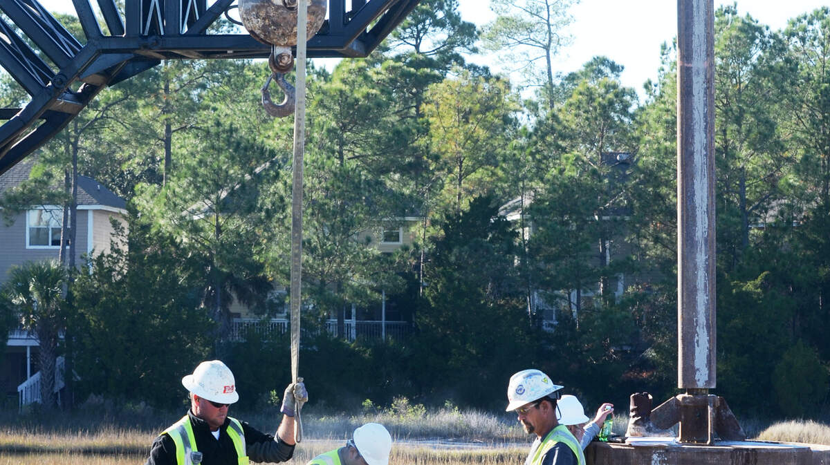 Work continues at the Bluffton Parkway flyover construction site on Dec. 16, 2013. The flyover will cost about $750,000 more than originally projected, but county officials planned for that circumstance with a $4 million contingency fund. The more than $36 million project includes construction of a 4,200-foot-long bridge segment over the marsh and 4,500 feet of road improvements. It is expected to be completed in October 2015.