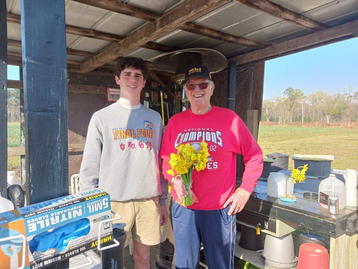 Co-owner Chuck Merrick and a bundle of daffodil blooms in 2025.