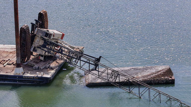 Crews still working to lift crane from Hilton Head waters after it tipped off barge