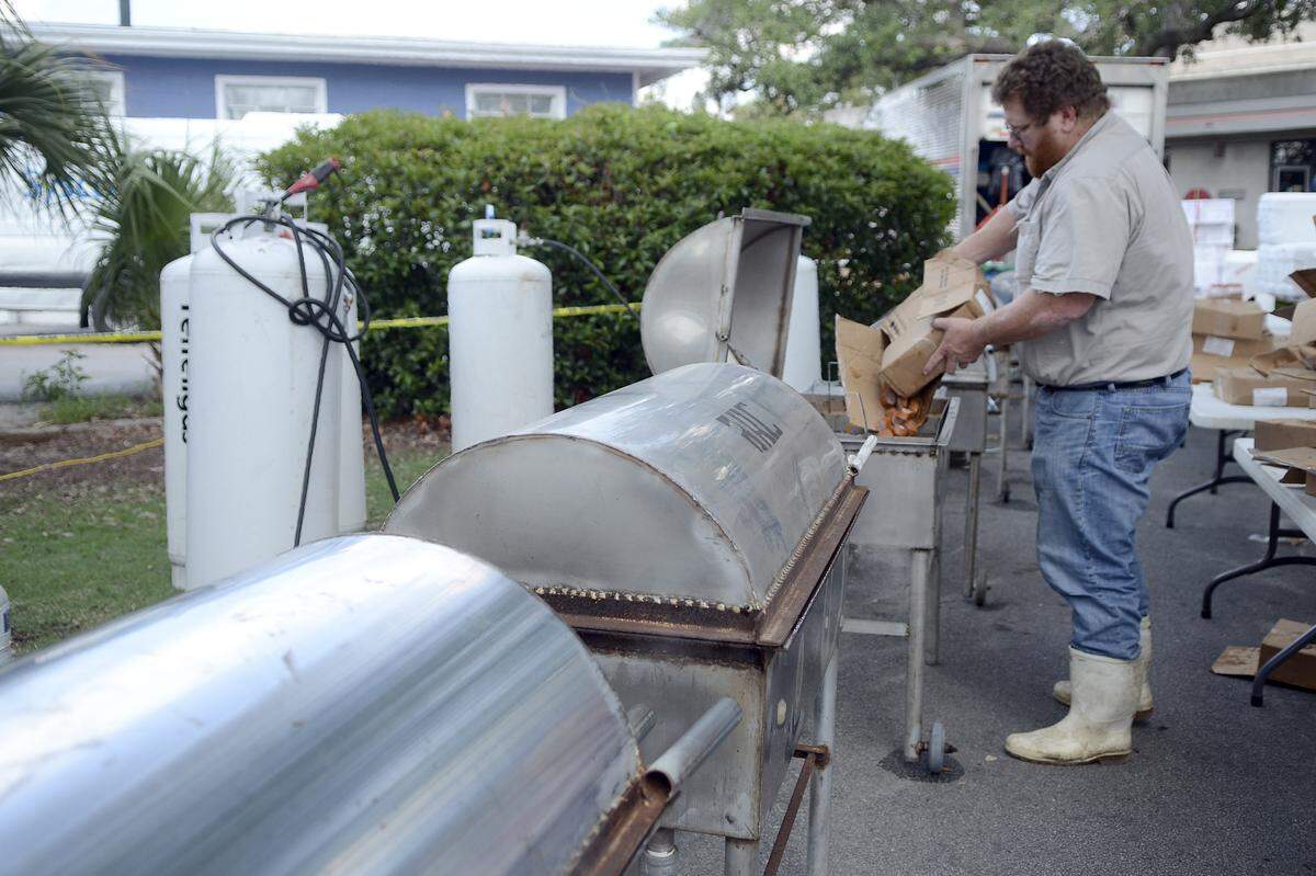 Craig Reaves, owner of Sea Eagle Market, drops sausage into the boiling water in preparation for the night’s Lowcountry Supper during the 2014 Beaufort Water Festival.