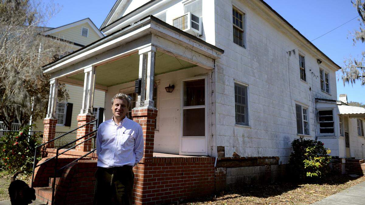 John Trask III of Beaufort stands in front of the Mulligan Grayson House on King Street in Beaufort on the afternoon of Feb. 27, 2014, that he plans to fix and stabilize so that it can be sold.