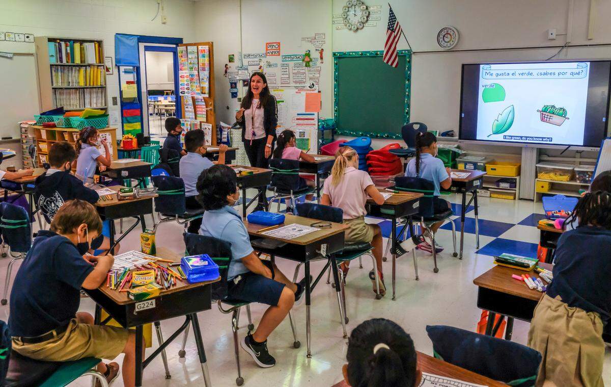 Carolina Diaz, a second grade Spanish immersion teacher works with her students singing songs in Spanish on Monday, Aug. 16, 2021 on the first day of school at Hilton Head Island Elementary School.