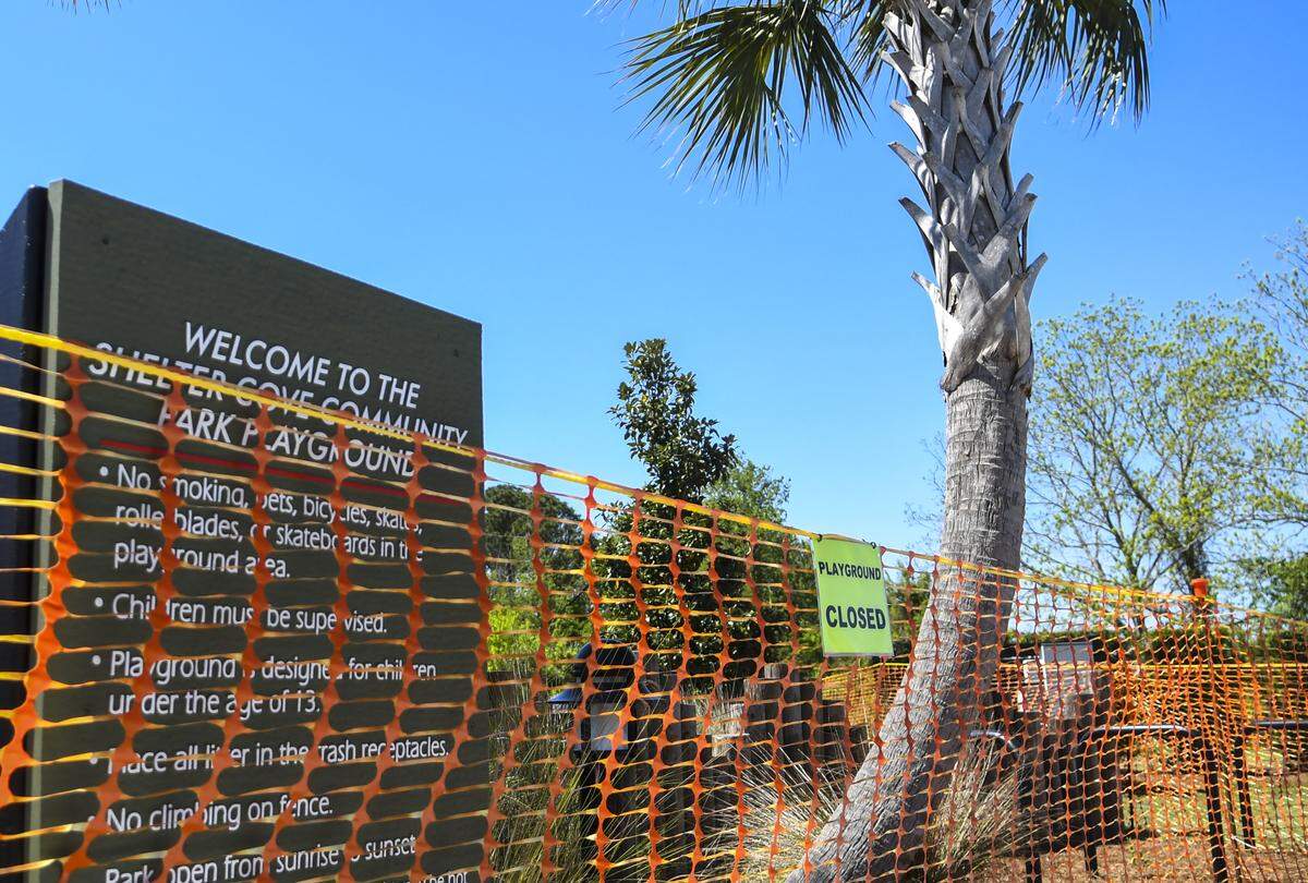 Construction fencing and signs inform the public that Shelter Cove Community Park Playground is closed as seen on Thursday, April 2, 2020, after S.C. Gov. Henry McMaster closed all beaches and parks in hopes of stemming the spread of the coronavirus.