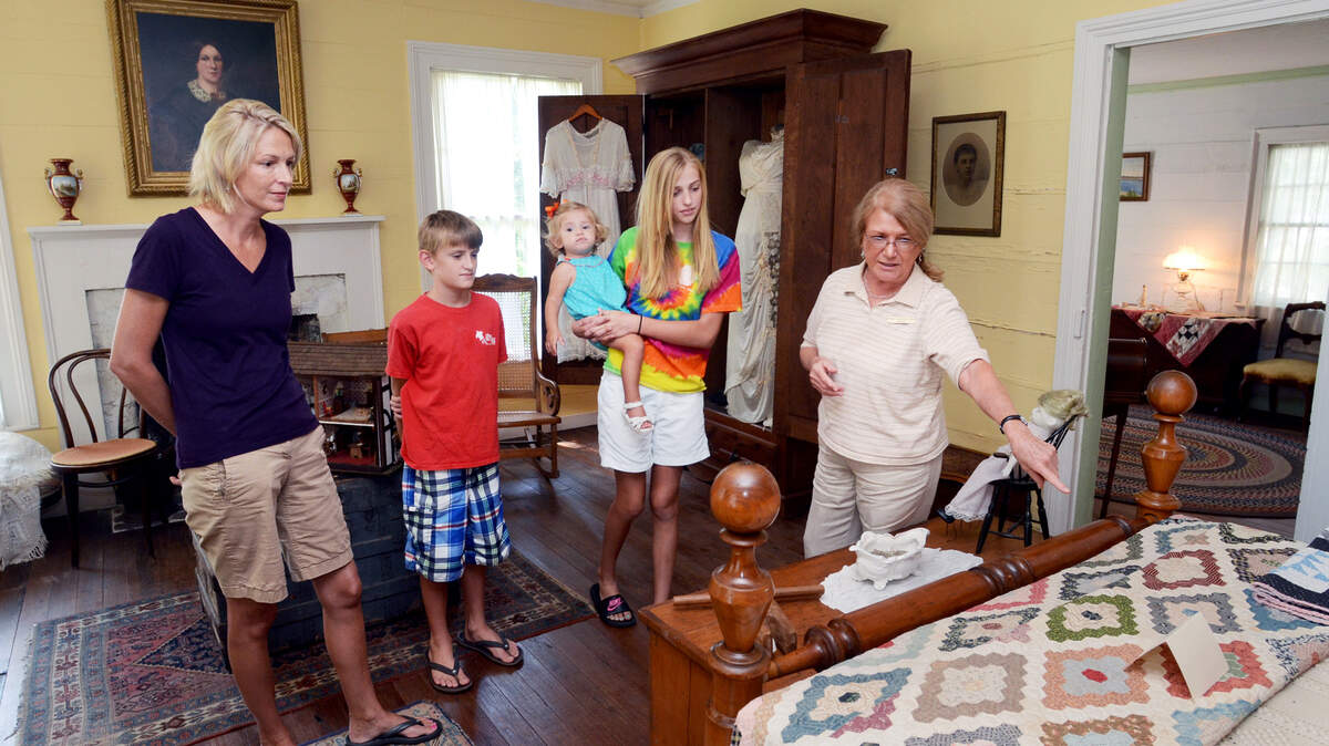 Heyward House Historic Center docent Sonie Phinney-Miller, right, gives a tour of the historic Bluffton house to Joy Tinney, of Bloomingdale, Ga., and Tinney's children, from left, Luke, 11, Caroline, 1, and Kate, 12. Officials in Bluffton are looking at making the Heyward House handicapped-accessible.