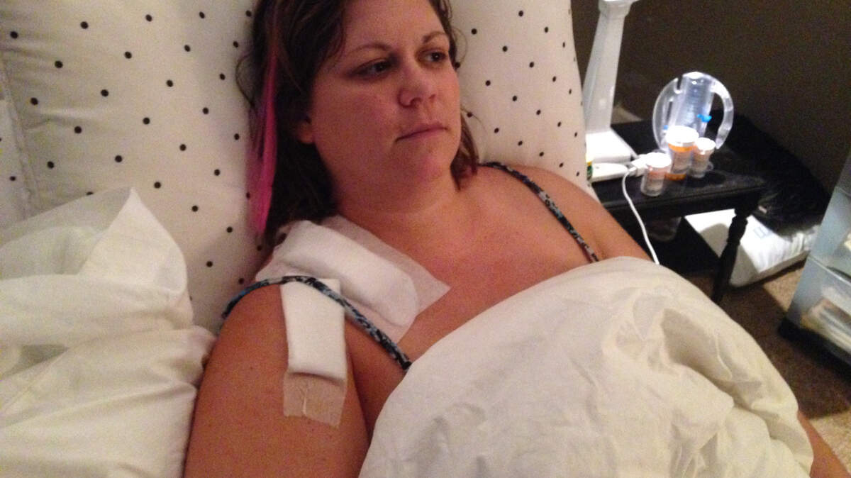 Meredith Irion, 34, of Lady's Island, is shown in this submitted photograph recovering in bed from severe chainsaw injuries she suffered to her right shoulder Oct. 12, 2013, when she was trimming tree limbs on her roof.