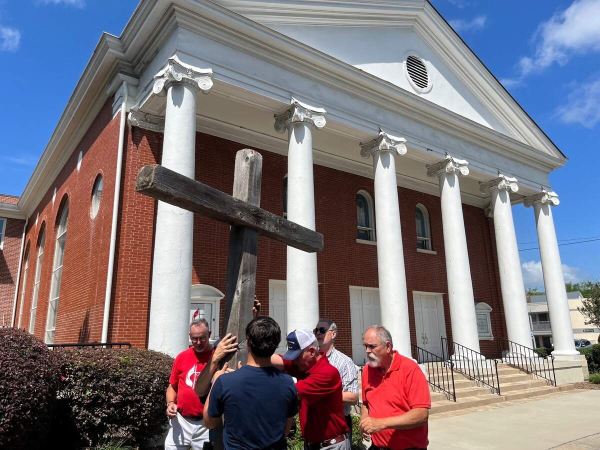 A cross is placed upright in a hole at United Methodist Church on Carteret Street in Beaufort after members carried it about 2 miles through the city in commemoration of Good Friday.