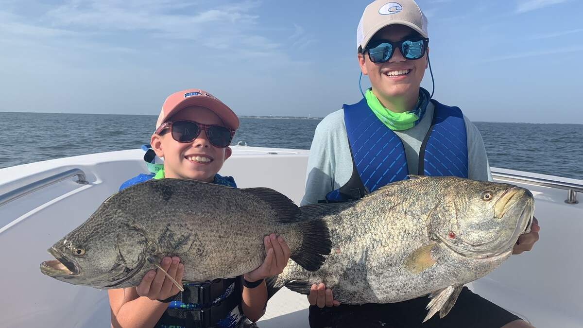 George Norton’s grandsons George and Beau with stud tripletails.