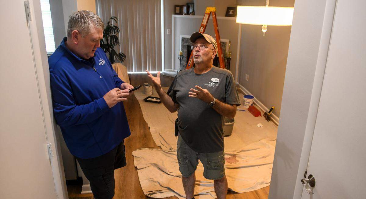 Kevin Carter, left, owner of Hilton Head Health, stands in one of his apartments as he looks through his phone to determine the number of properties he has purchased as Rob Moonen, the wellness resort’s facilities director and project manager recounts them out loud on Thursday, Aug. 18, 2022 on Hilton Head Island. Carter and Moonen determined that they have 19 units with a total of 26 bedrooms that are rented to employees.