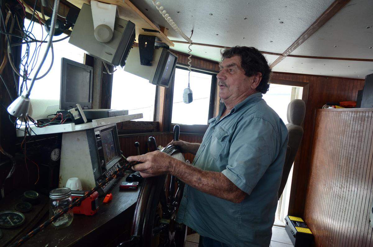 Laten Reaves, captain of the Gracie Belle, steers the trawler toward the area he plans to catch shrimp Sept. 6 off St. Helena Island.