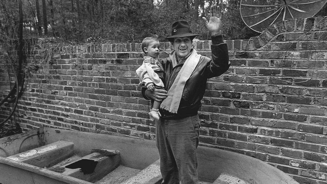 Henry Ingram and a granddaughter standing in his “bird feeder” in a patio behind his home on Club Course Drive in Sea Pines on Hilton Head Island in 1990.