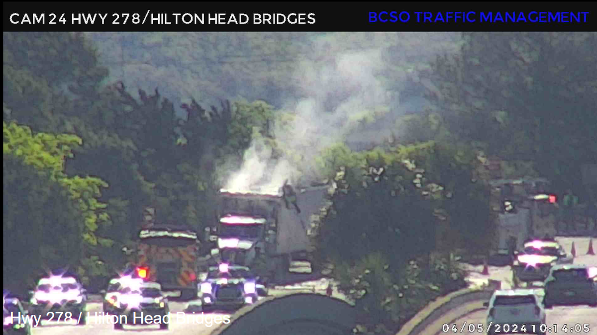 Fire crews work to extinguish a flaming vehicle on the Hilton Head bridge on Friday, April 5, 2024.