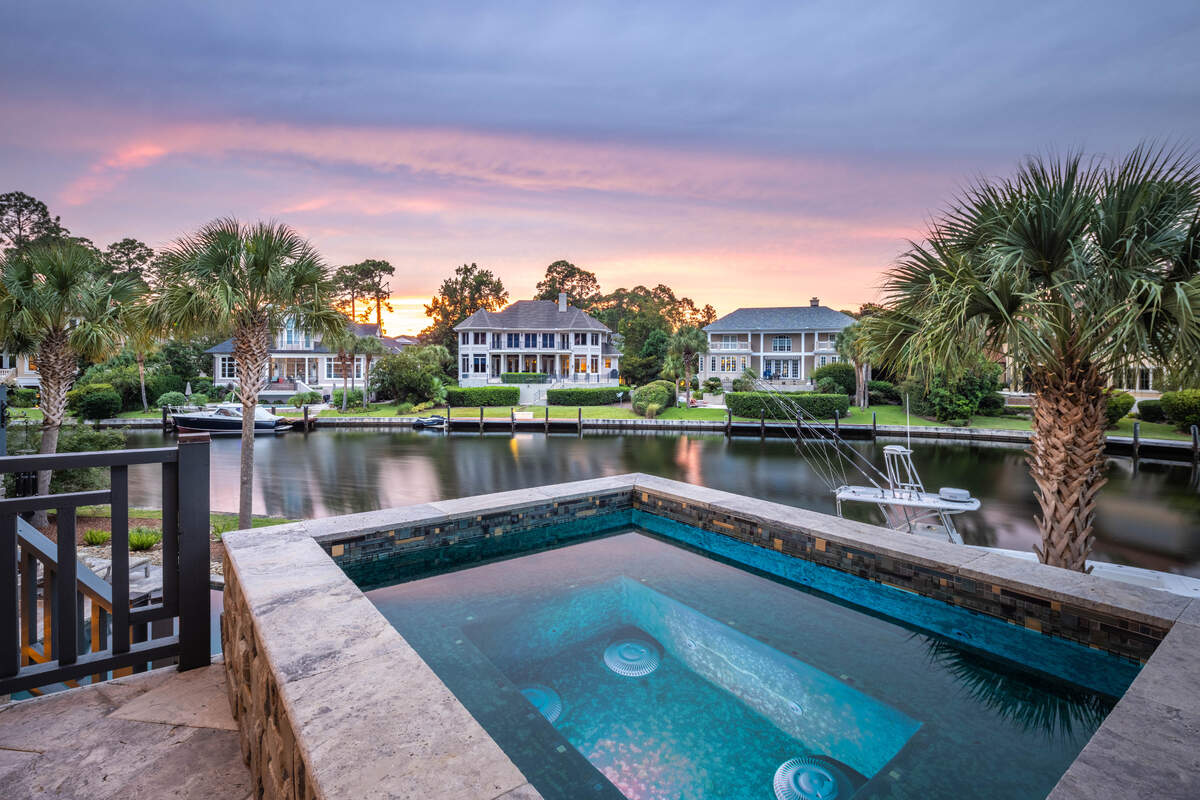 A view of the outdoor living space, including the harborside spa and pool, found at 36 Plumbridge Circle on Hilton Head Island, SC.