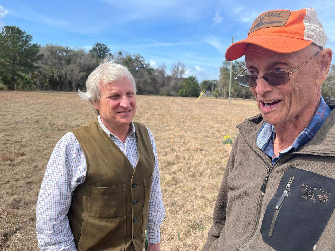John Trask and Dudley Holmes, the caretaker of the Trask property on Upper Cane Island for 30 years, discuss the barrier island’s history. “I don’t want to lose the history of this place,” Holmes says. “It’s really important.”